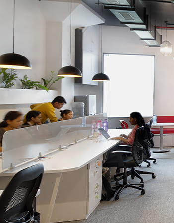 office interiors with white table and carpet flooring, people working peacefully